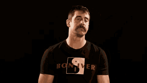 a man with a mustache wears a black shirt with the word boxer on it