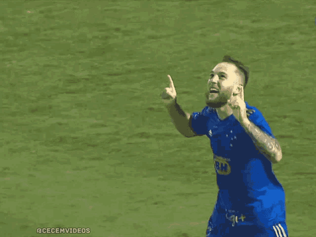 a man in a blue shirt with bh on the front