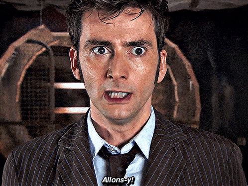 a man in a suit and tie is saying " allons-y "