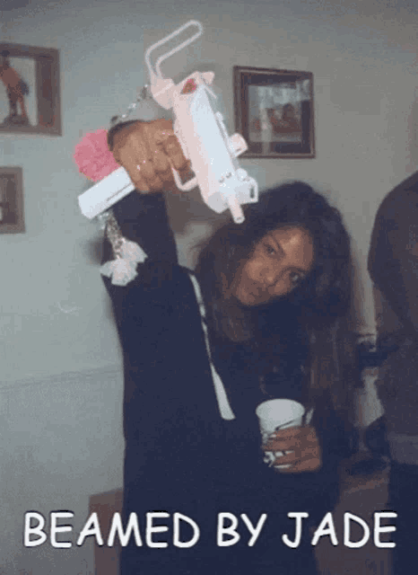 a woman holding a gun with the words " beamed by jade " on the bottom