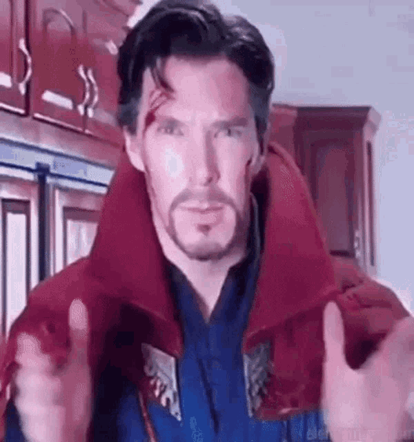 a man in a doctor strange costume is pointing at the camera .