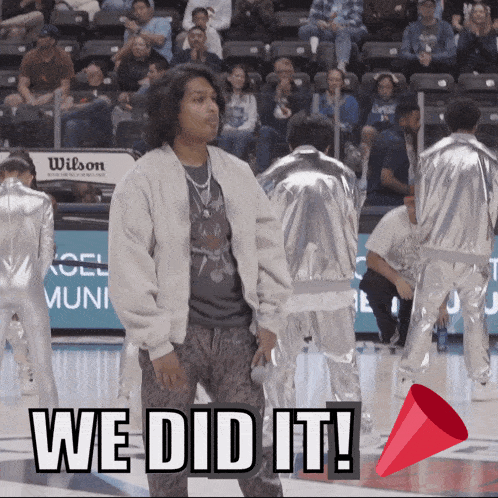a man stands on a basketball court with the words we did it written on the bottom