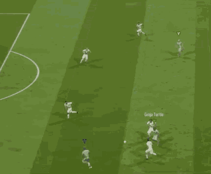 a group of soccer players are playing a game on a field with a yellow triangle in the middle