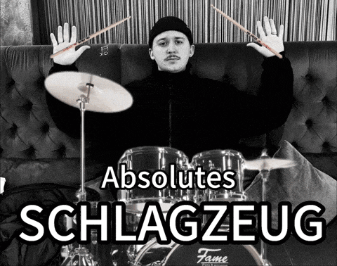 a black and white photo of a man playing drums with the words absolutes schlagzeug below him