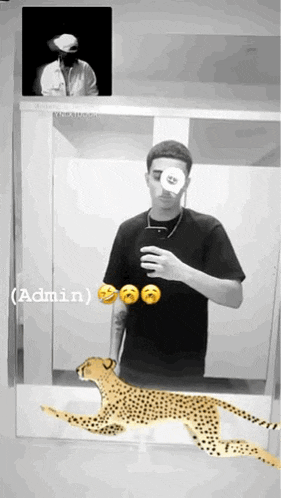 a man is taking a picture of himself with a cheetah in front of a mirror ..