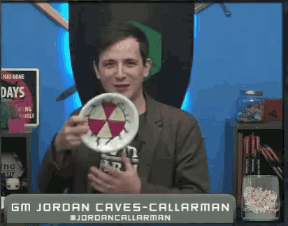 gm jordan caves-callarman is holding a plate in front of a sign that says has gone days
