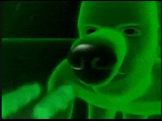 a close up of a green monster 's face with a glowing nose and mouth .