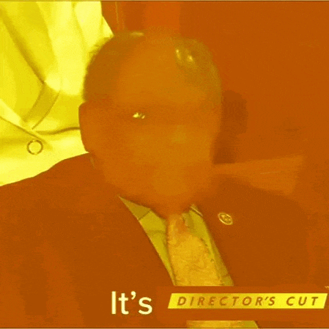 a man in a suit and tie with the words it 's director 's cut below him