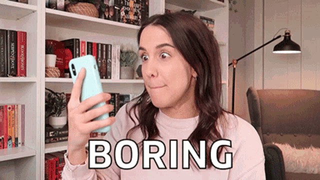 a woman is looking at her phone and the word boring is on the bottom