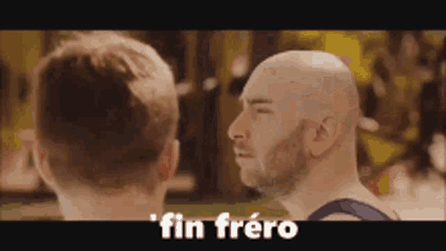 a man with a beard is talking to another man in a video .