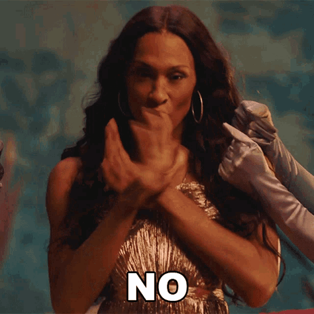 a woman in a dress says no with her hands outstretched