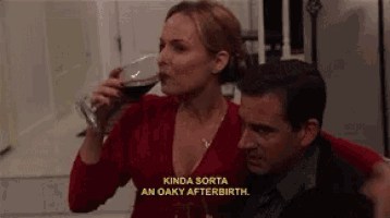 a woman is drinking a glass of red wine next to a man and says kinda sorta an oaky afterbirth