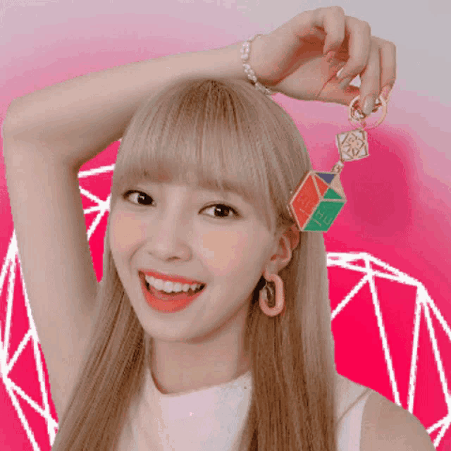 a woman holding a keychain that says " hi " on it