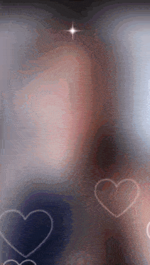 a blurred image of a person with hearts floating around them