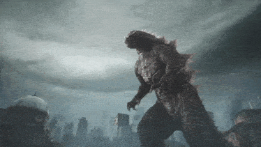 a large monster is standing in front of a city with a dome in the background