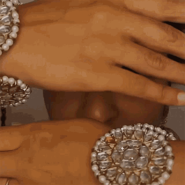 a close up of a woman 's face with a hand covering her eyes