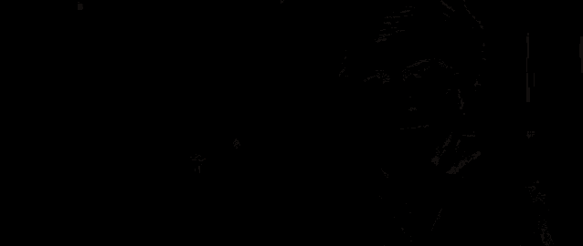 a man wearing sunglasses is smoking a cigarette in a dark room