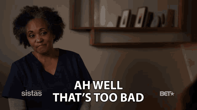 a woman says ah well that 's too bad in front of a shelf
