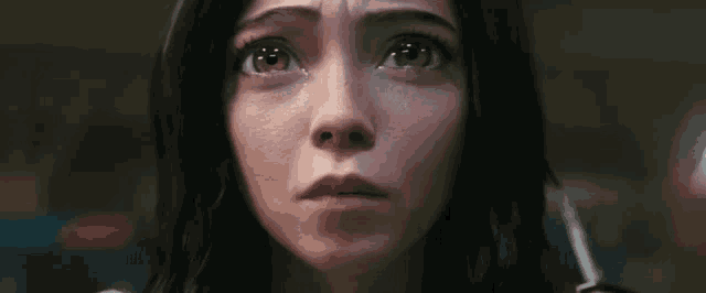 a close up of a woman 's face with tears running down her eyes .