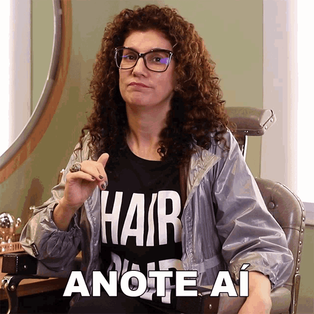a woman with curly hair wears a black shirt that says hair anote ai