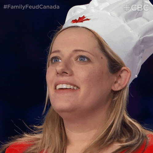 a woman wearing a chef 's hat with a maple leaf embroidered on it