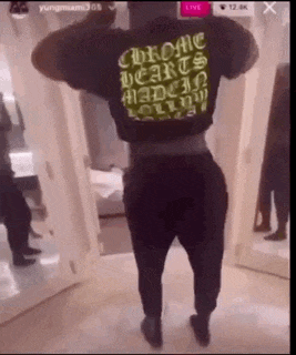 a man wearing a black shirt that says chrome hearts on it