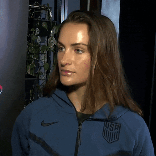 a woman wearing a blue nike jacket with a usc emblem on it