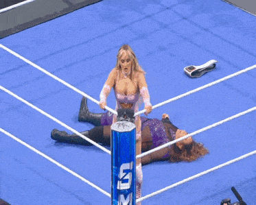 a female wrestler in a pink outfit is jumping over the ropes