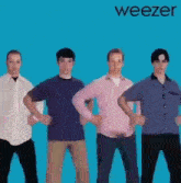 a group of men standing next to each other with their hands on their hips in front of a weezer album cover