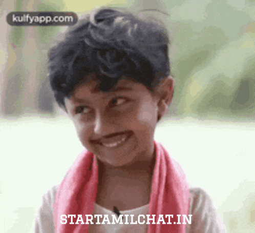 a young boy with a pink scarf around his neck is smiling and looking up .