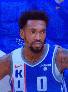 a basketball player wearing a blue jersey that says k on it