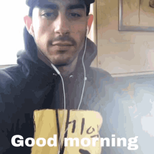 a man wearing headphones and a shirt that says hello says good morning