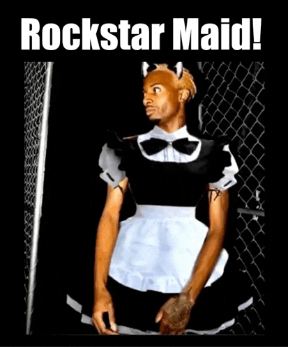 a man dressed as a maid is standing in front of a chain link fence with the caption rockstar maid