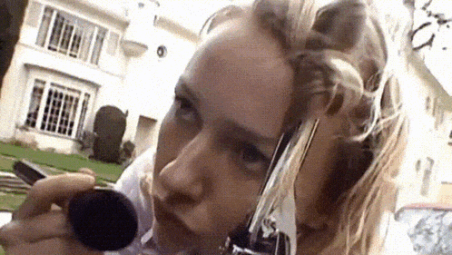 a woman with curlers in her hair is holding a brush in her hand
