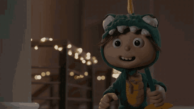 a cartoon character in a dinosaur costume is holding a star