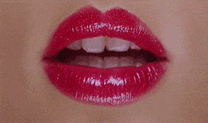 a close up of a woman 's lips with red lipstick and white teeth
