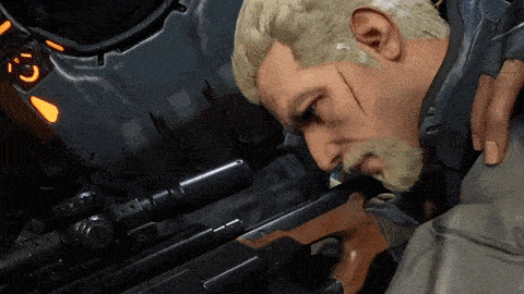 a man with a beard is looking down at a rifle