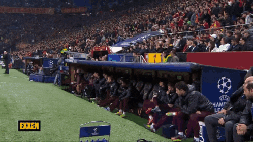 soccer players sit in a dugout with the word ekken on the bottom