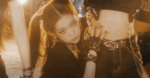 a woman wearing a choker and gloves has a tattoo on her forehead that says ' lady '