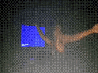 a blurry image of a person dancing in front of a blue screen
