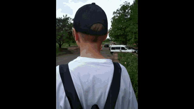 a person wearing a black hat and a white shirt