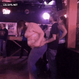 a woman is dancing with a man in a bar with lolgifs.net at the bottom
