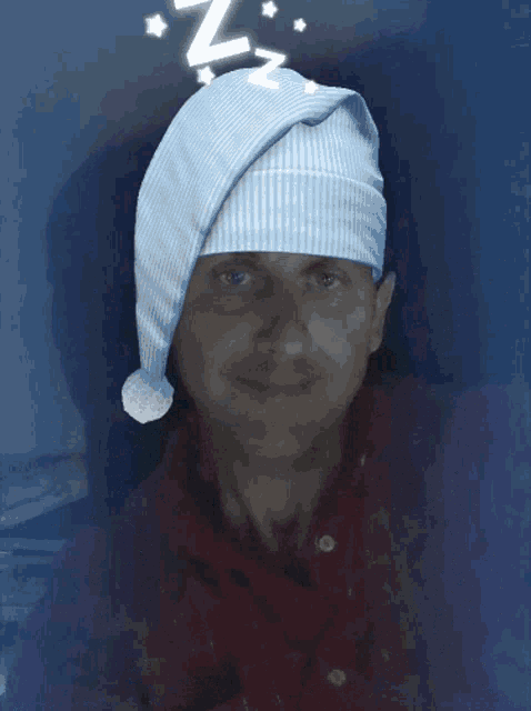 a man wearing a santa hat is behind a gray background