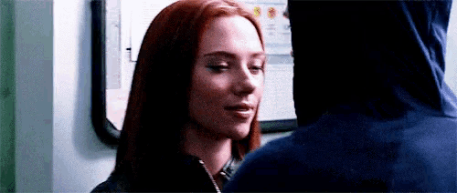a woman in a hoodie is looking at a man in a hoodie .