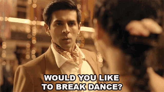 a man in a suit is talking to a woman with the words " would you like to break dance " written below him