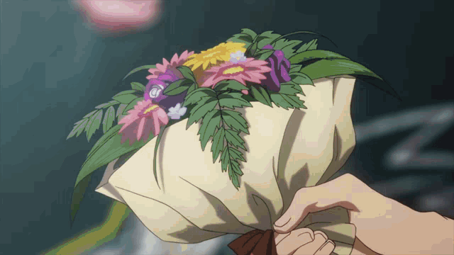 a person is holding a bouquet of flowers with the letter g on the top