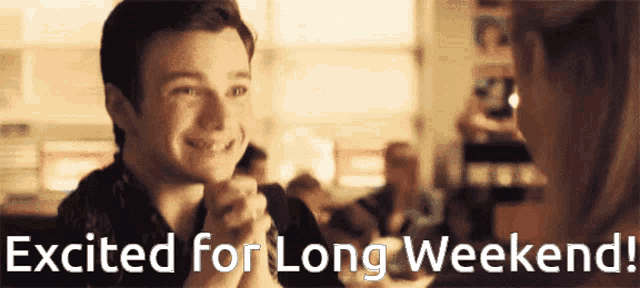 a man and woman are sitting at a table with the words excited for long weekend written below them