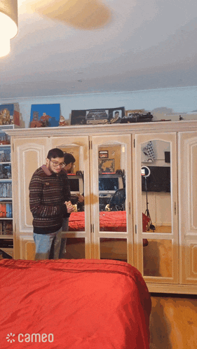 two men standing in front of a wardrobe with cameo written in the corner