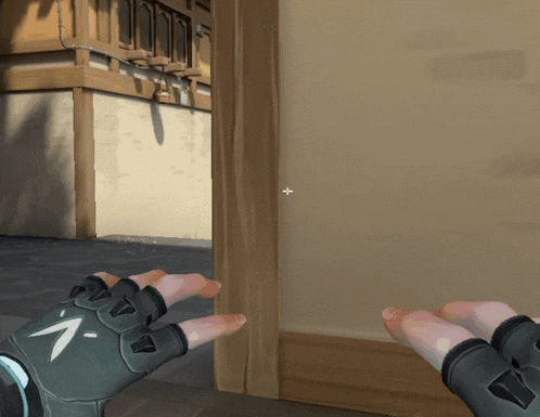 a person wearing a glove with an arrow on it is standing in front of a door