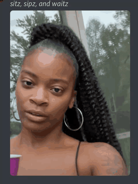 a woman with a ponytail and hoop earrings looks at the camera with the words sitz sipz and waitz above her